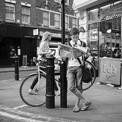 Reading Newspaper in a street | Black and White Street Photo