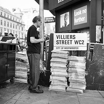 Piled Up Newspapers | Black and White Street Photo